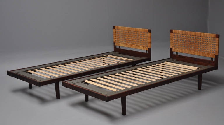 Pair of single beds by Hans J. Wegner. The frames of teak with woven headboards. The beds designed by Hans J. Wegner and produced by GETAMA, Gedsted.