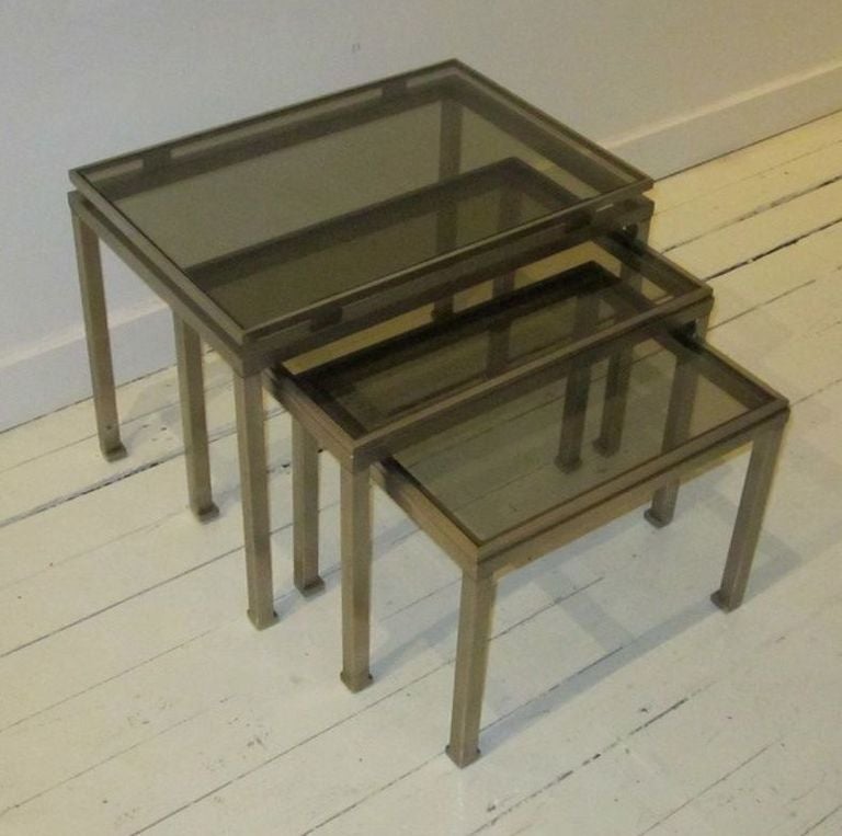 Brushed steel with glass set of three nesting tables.
Measures: 19 x 14 x 15,
17 x 13 x 13,
15 x 11 x 11.