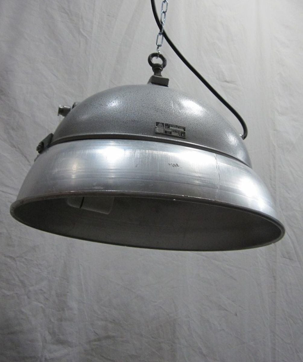 Oval aluminum industrial light fixture reissued with new wiring.