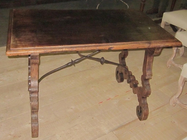 19th century Italian walnut fratino tavolo side table with iron cross bar base.
Beautifully carved leg detail.