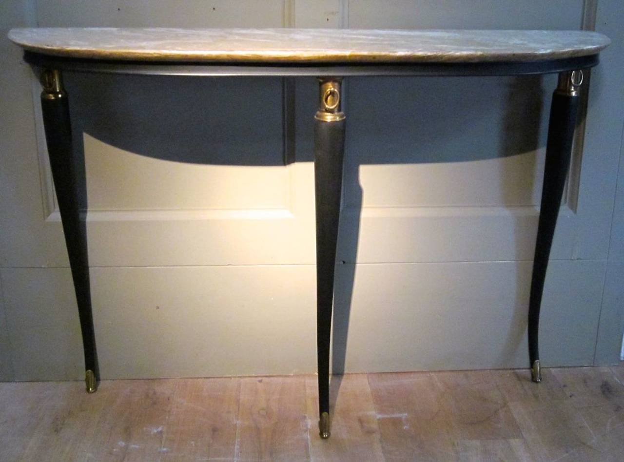 Marble top, ebonized base, demi-lune console table from Italy, mid-century. Three slender legs have brass details at the top and foot of each leg. The marble top is light grey with white veins.
The table is in excellent condition.
It will arrive