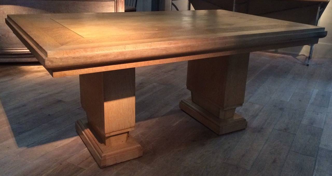 French 1940s large blond oak desk with diamond parquet pattern. The top of the desk has a diamond parquet pattern in the centre of the desk and is framed by two borders of oak. Two thick oak rectangular columns form the base of the desk. The desk is