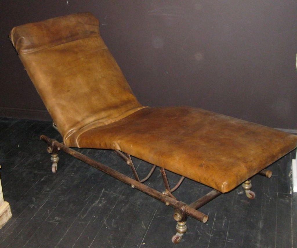 One of a kind leather chaise that reclines to a flat position or raise it to various seating heights. The thick leather cushion is made from a vintage 50's gym mat.<br />
The chaise is on wheels for easy movement.