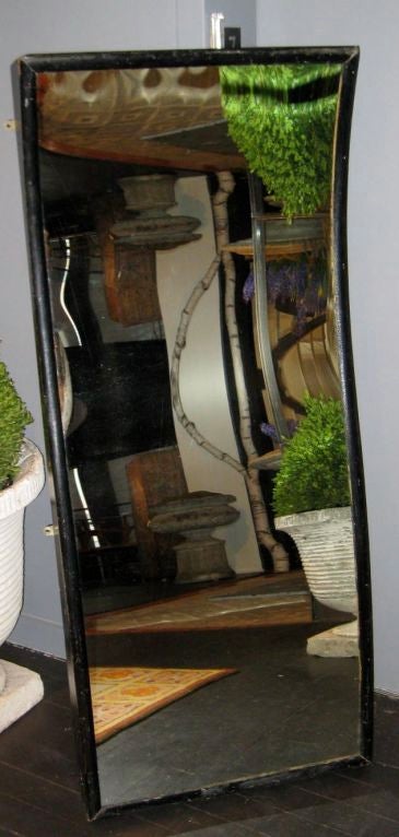 Unique concave mirror with a thin black frame. The mirror gives off a view like the old time funhouse mirrors. Great one of a kind item.