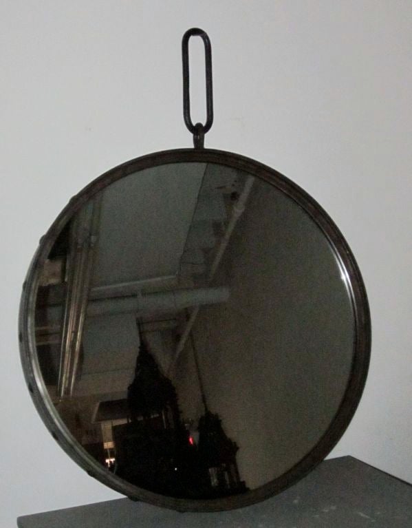 Contemporary Industrial steel round wall mirror with large rivets surrounding the frame.
Mirror also available in nickel-plated.
Hangs from oval steel hook and wall plate, or you can remove the hook and just hang it from a cross bar in the back of
