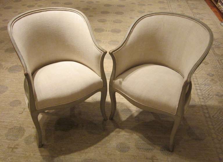 Pale grey frames accent this pair of comfortable French pull up chairs.
Recently reupholstered in vintage Belgian linen.