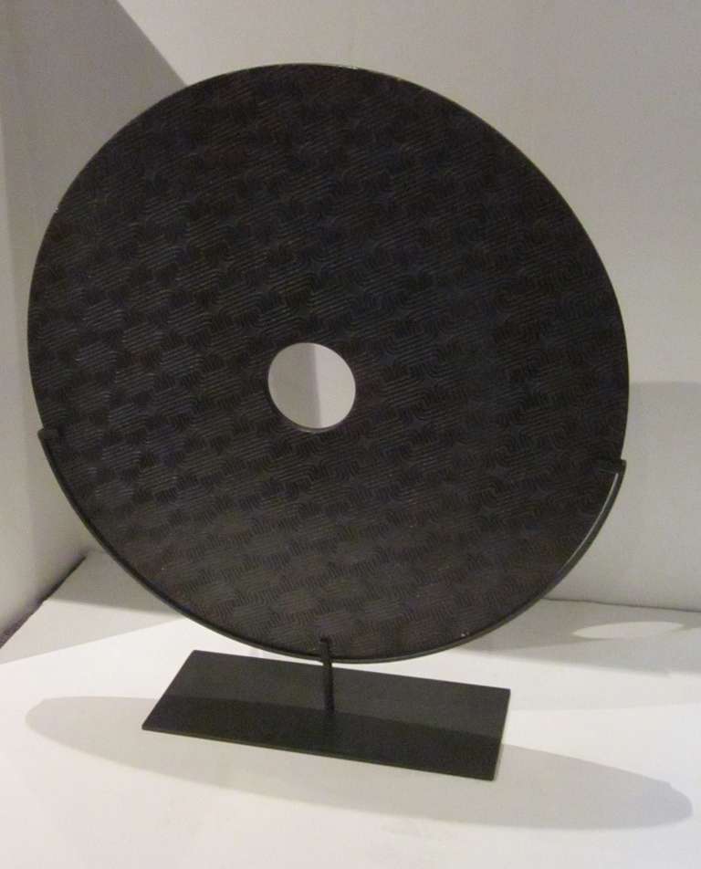 Chinese X large brown textured natural stone disc on metal stand.