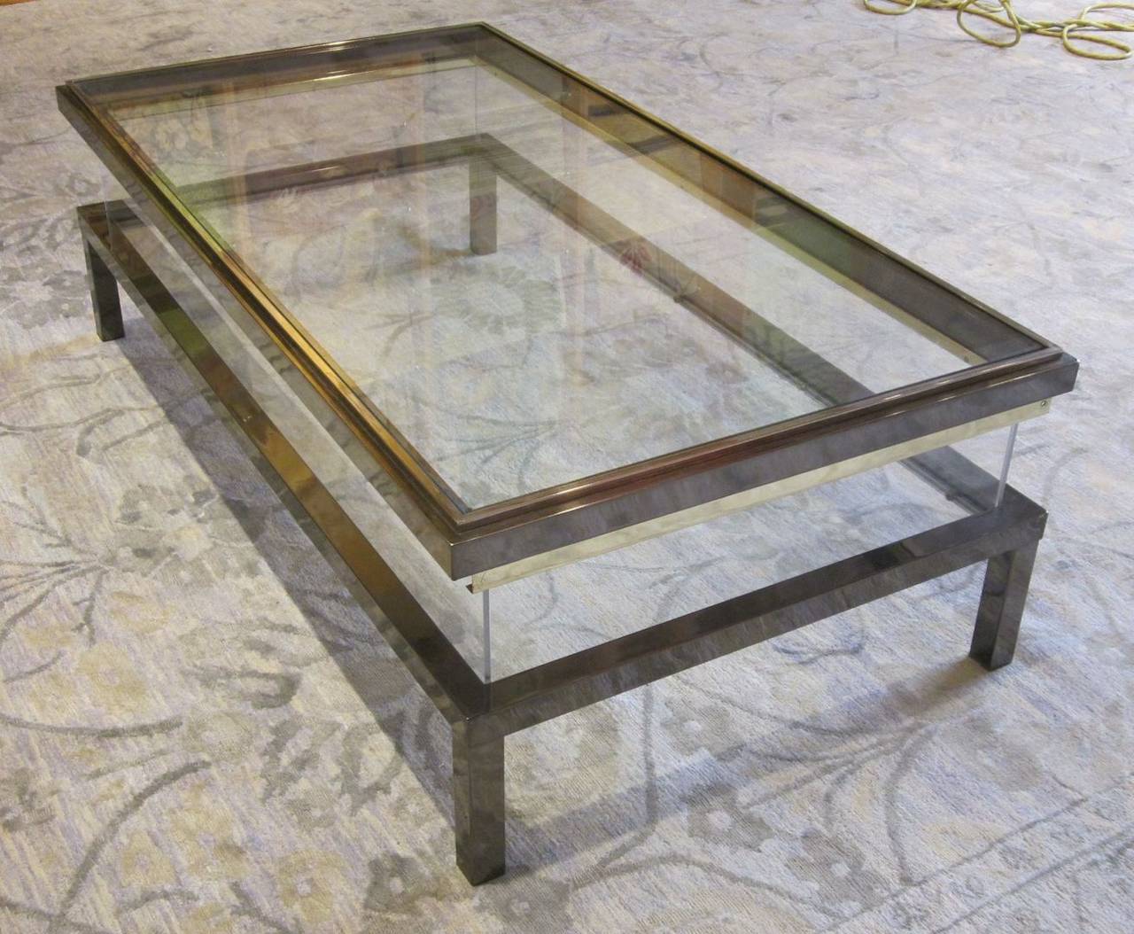 Rectangular vitrine coffee table.
The top slides back to expose the inner shelf.
Plexi sides and glass top and shelf.