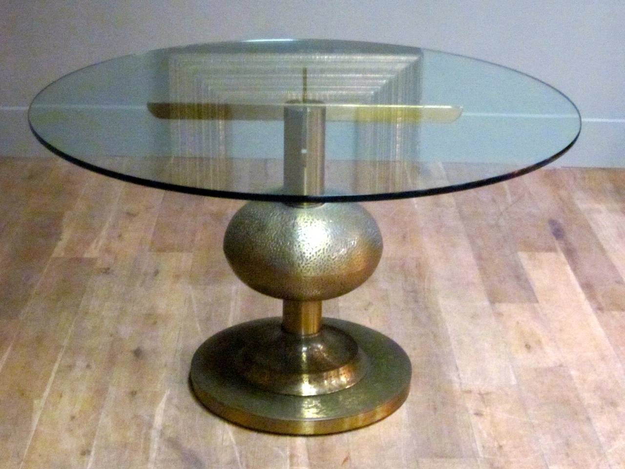 Hammered brass base. Glass top dining table. Italian by Luciano Frigerio.