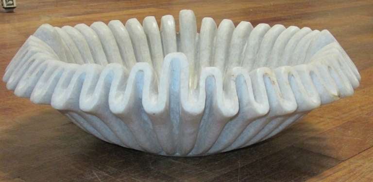 Marble bowl with very delicate and intricate fold design, resembling a pie crust.

  