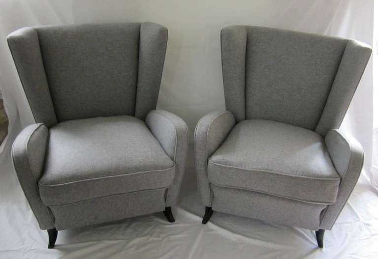 High back club chairs with a separate cushion. Recently upholstered in grey flannel. Very comfortable.