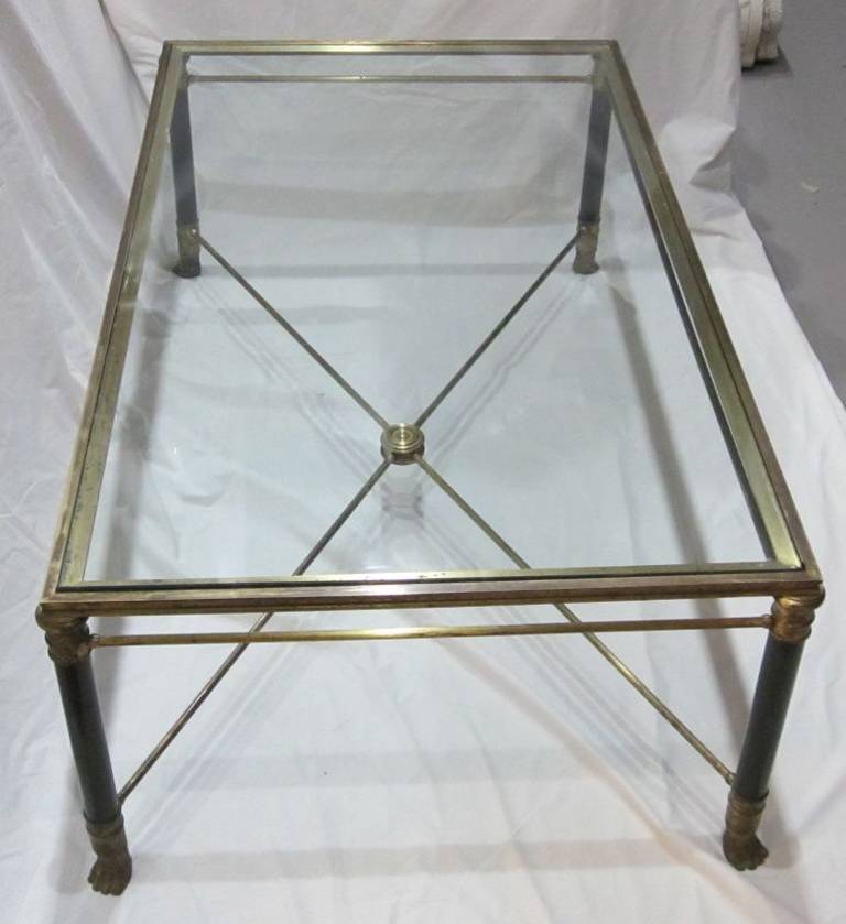 Maison Jansen glass top, brass claw foot coffee table.