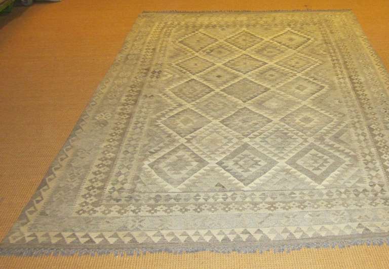 Shades of grey Kilim with large diamond center field pattern.
Vegetable dyed wool.
Reversible.