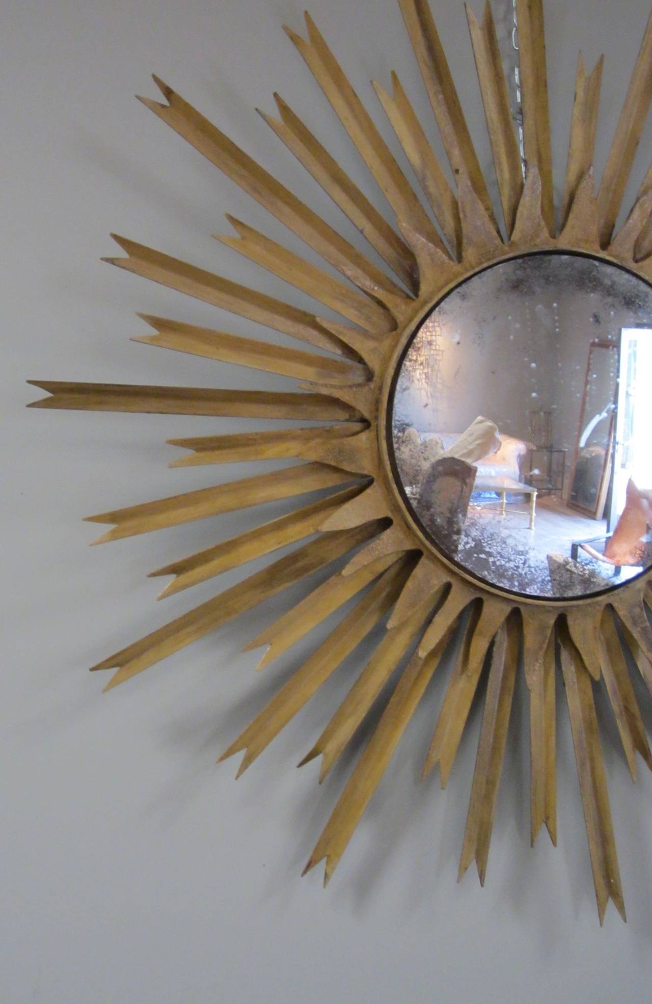 Mid-Century French gold gilt metal star burst wall mirror.
The mirror is original and slightly distressed as is the frame.
 