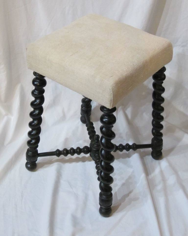 19thC ebony foot stool with classic twisted spool legs. Vintage Belgian linen upholstery.