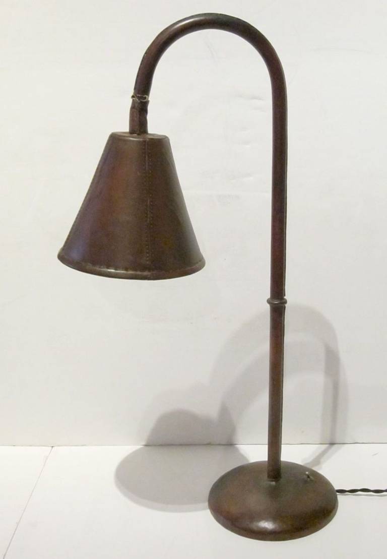Valenti 1960s Spanish Mid-Century burgundy leather desk lamp. The lamp is leather all-over with self color top stitching on all seams. It has been rewired for the USA and is in excellent condition.
Base measures 8