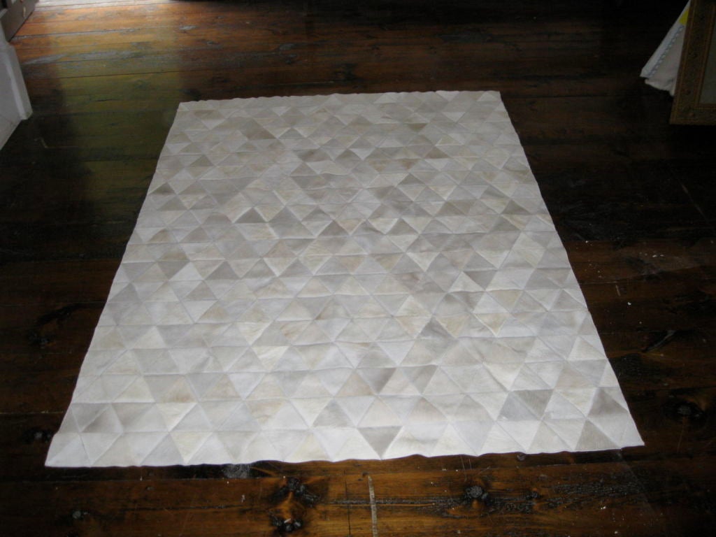 Multi shaded patchwork rug with triangle patches.