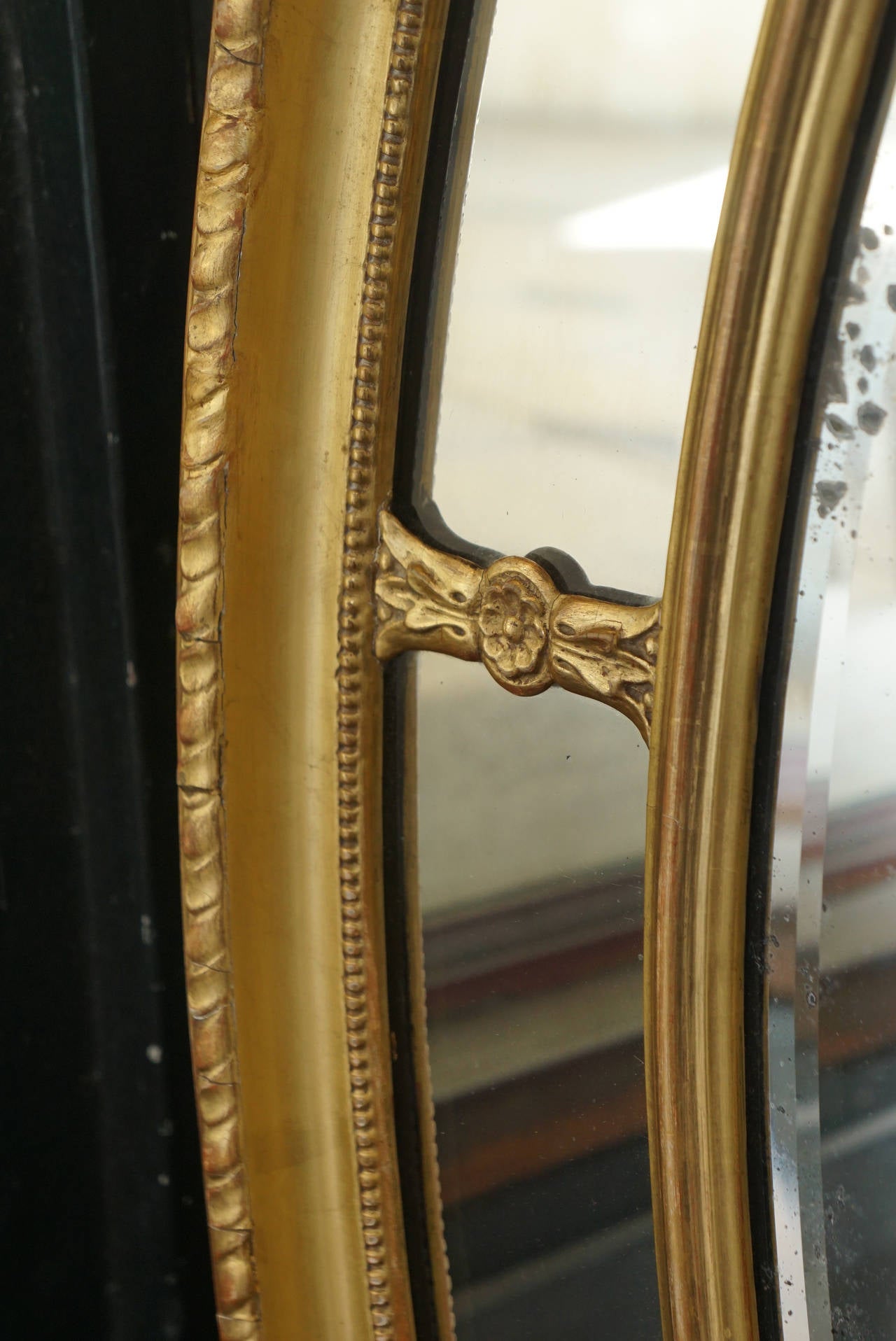 This fine vintage mirror is made of wood and gesso which has been matte and burnished water gilded. The piece was most likely made in England. The form is a Fine example of the type and shows many fine details. Created as a central panel with a