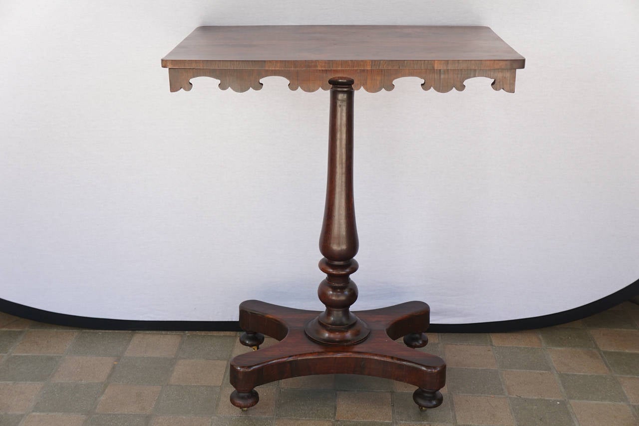 This Fine small table made in England circa 1850-1860 shows many elements of the early Regency and William IV periods. The wood selection is excellent with abundant grain striation and color. The top is set on a modified Gothic apron raised up on a