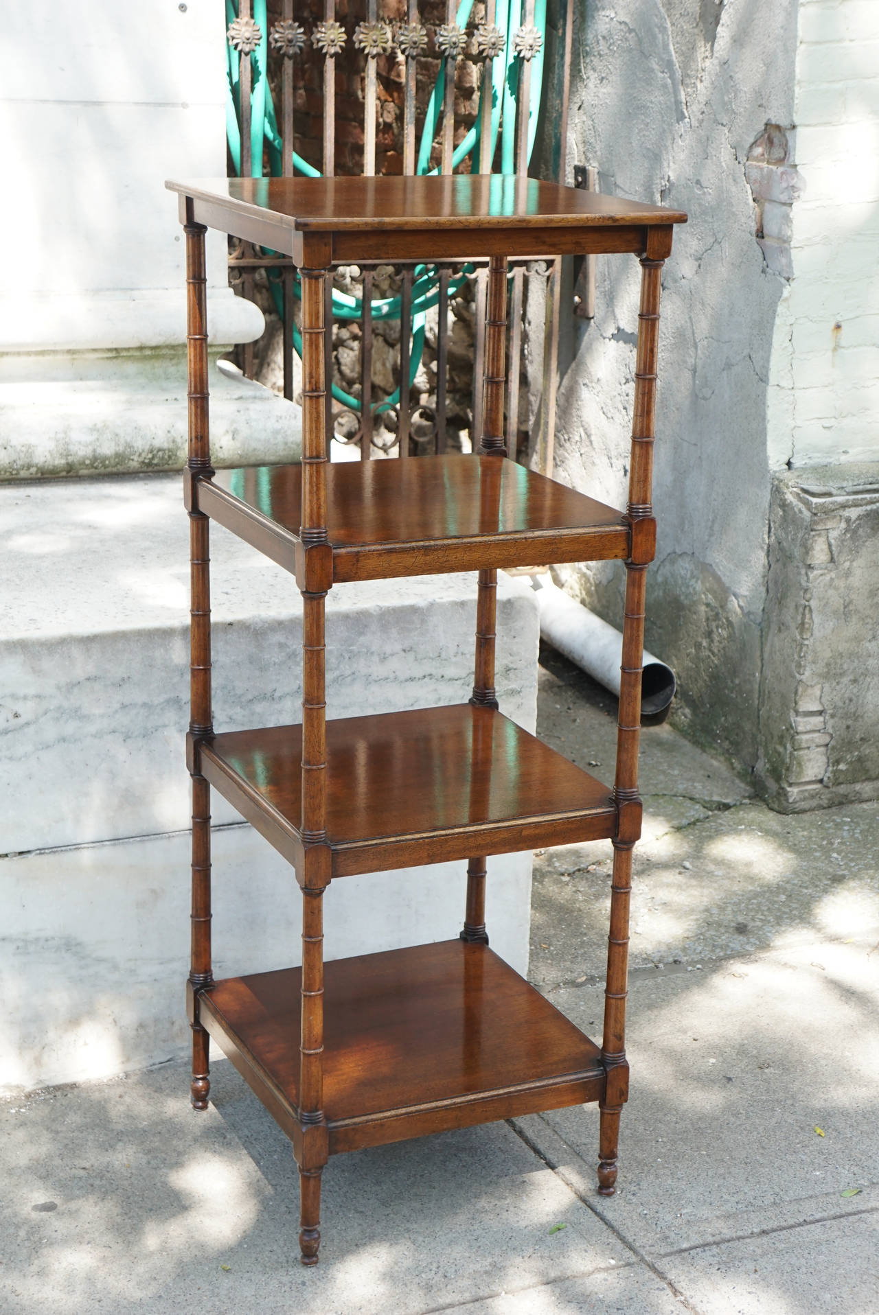 This nice Edwardian étagère with four tiers has a great old color and patina. The piece made from mahogany in England circa 1880-1900 to appear like Regency versions and without much change was and still is a staple of design usable in many
