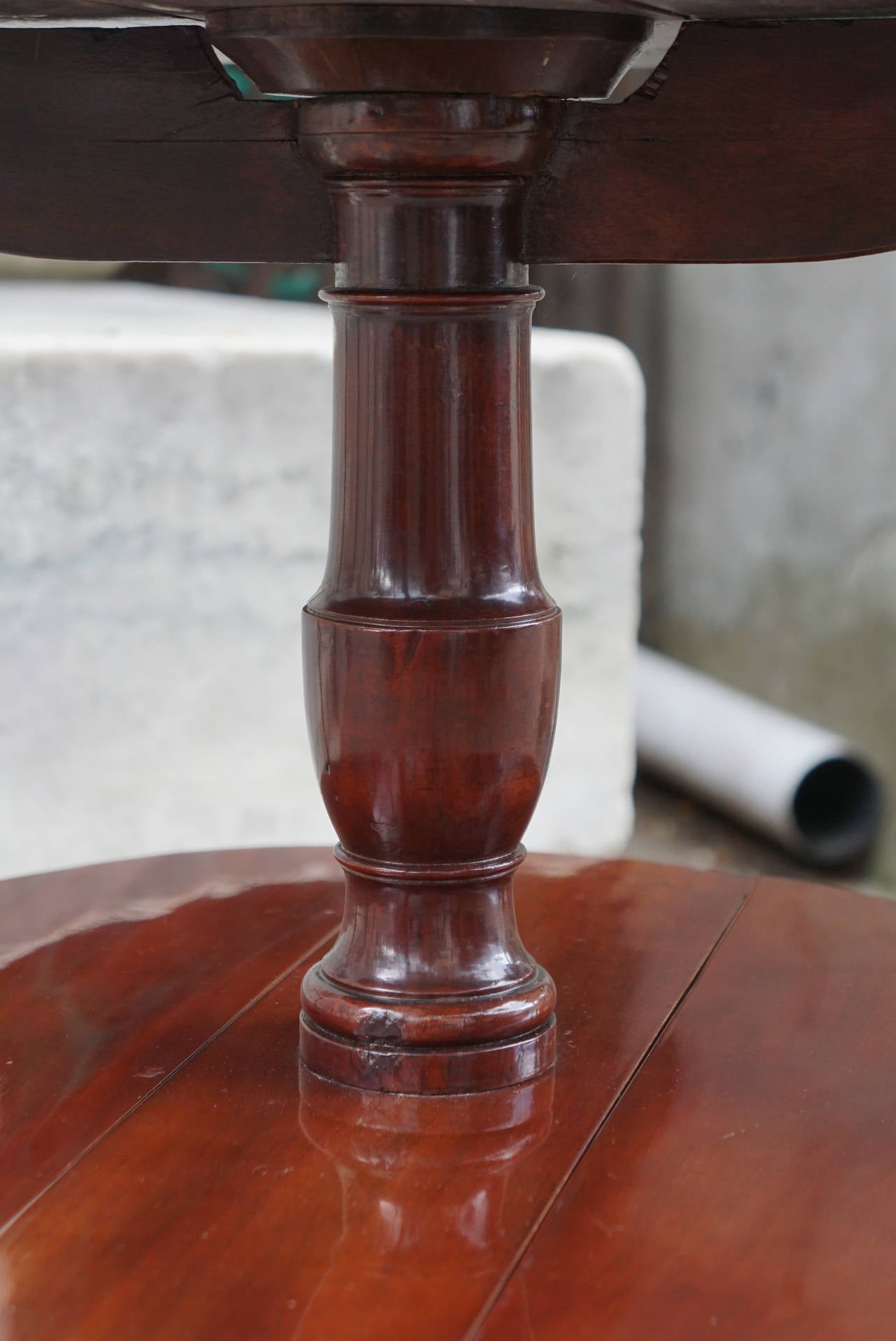 This piece made in England, circa 1770 is of an unusual size and with the added feature of folding drop leaves. Made from solid mahogany without veneers the piece is heavy and mannish with a deep rich color to the wood. The table is accented with
