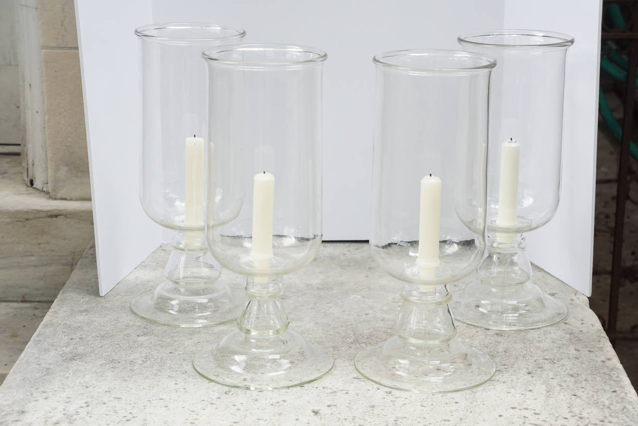 These two pairs of handblown glass photophores or hurricanes were made in France. Vintage and decorative in nature they are of a nice large size and come with blown glass candleholders that are removable and make cleaning and use easier. Blown in a
