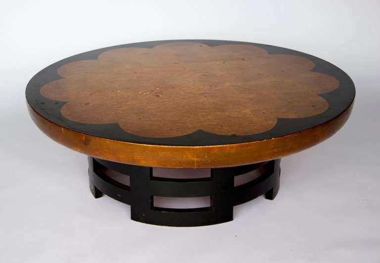 Bold and Graphic Gilt Circular Coffee Table with Stylized Lotus Motif
Designed by Muller snf Berringer for the KITTINGER COMPANY
A Lovely Gilt and Painted Finish on the Circular Top.  Black Laquered Finish
onthe Fret worked Base