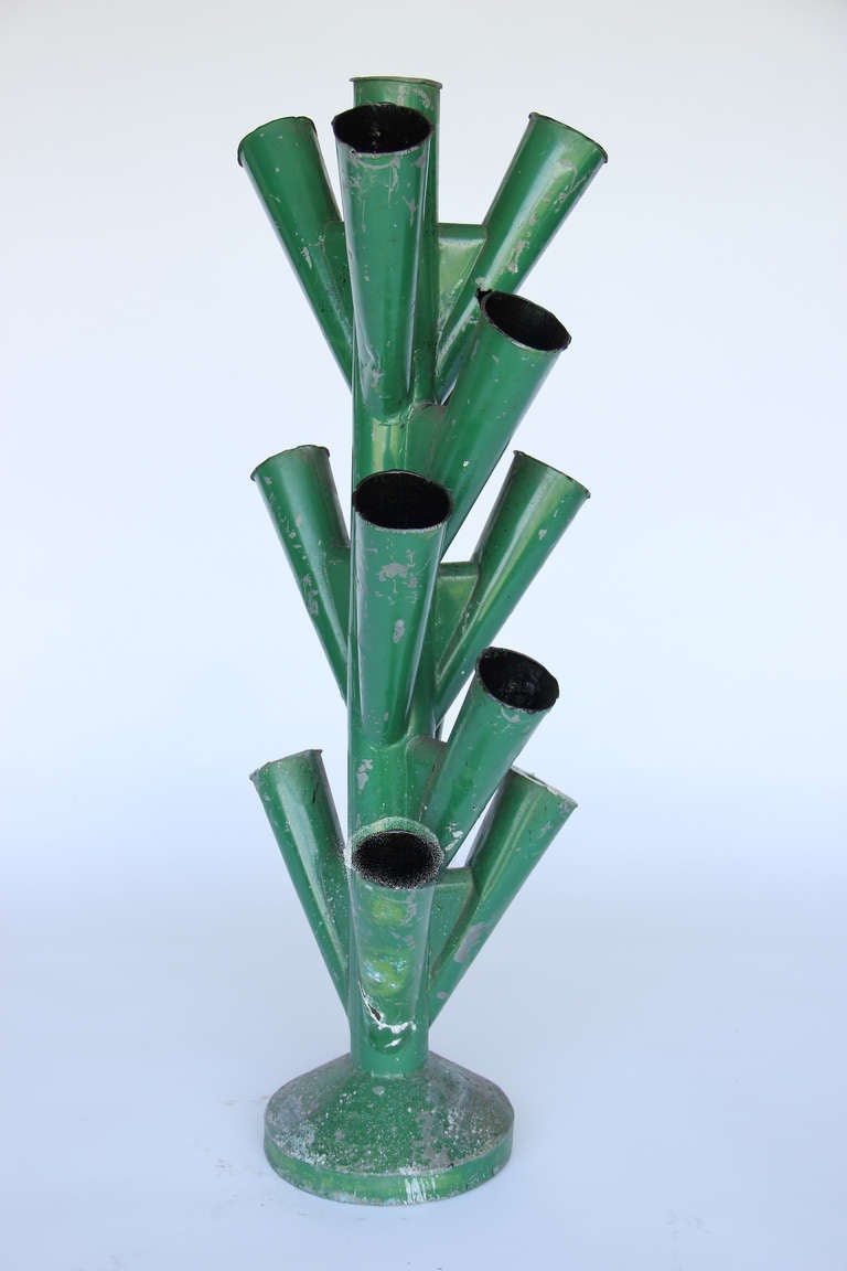 Green tole French flower market bouquet holder with 14 flower pockets.  As the metal has worn holes in some of the pockets, would suggest placing flowers and water in glass floral tubes or vials.