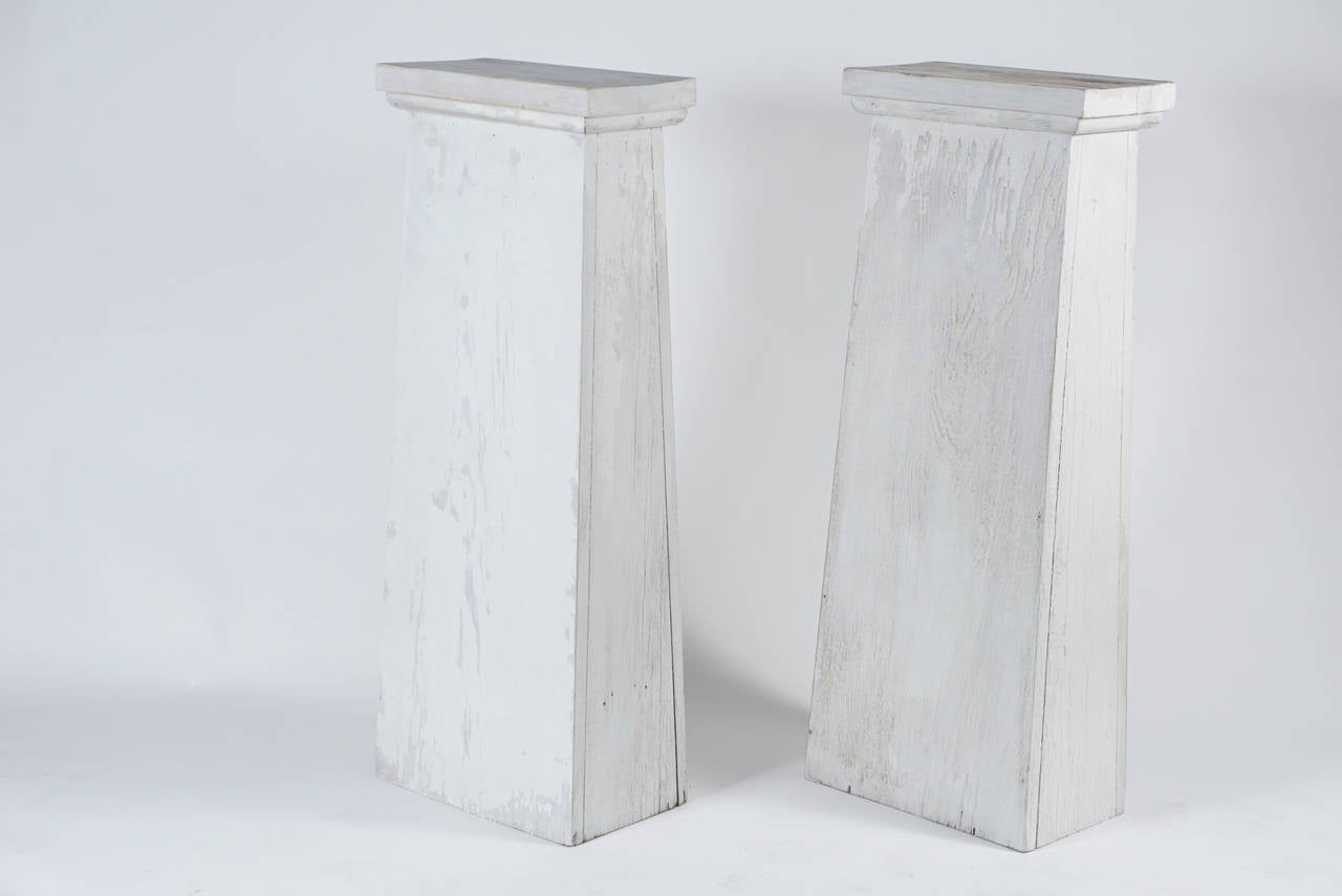 Architectural Plinths in white paint. A solid form and useful as a tall pedestal.

 