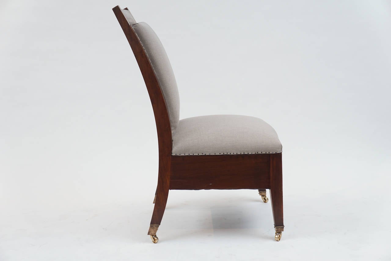 From a Dearborn Michigan Estate built in the, early 1920s.
The chair has a bold proportion and is easily moved on brass casters.
Upholstered in Sturdy Canvas.