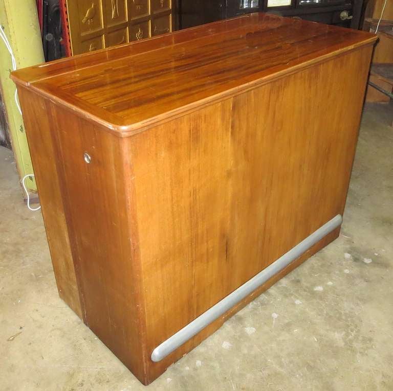 RETIREMENT SALE!!!  EVERYTHING MUST GO - CHECK OUT OUR OTHER ITEMS.

This amazing bar cabinet began its life on a noted American families yacht. When closed, the mahogany cabinet is devoid of all decoration, except a metal rail on the front and a