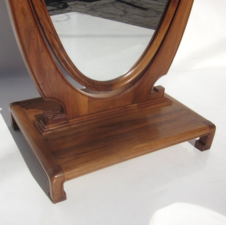 This lovely classic mirror will look sensational in any setting. Its' understated styling should blend easily with any traditional or more modern interior. The woods are finished walnut, with brass knobs. The mirror is framed in walnut, and can be
