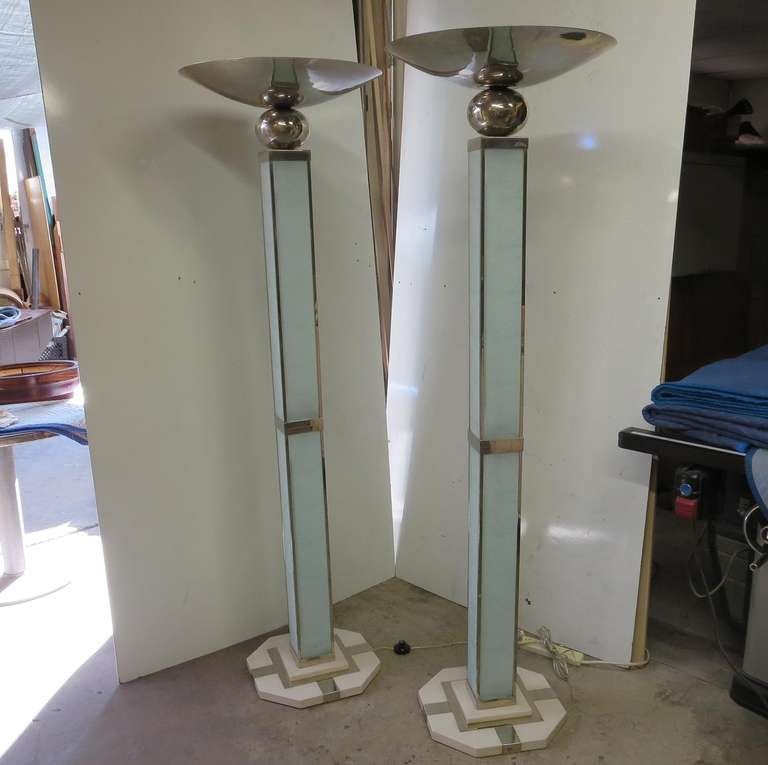 This fantastic pair have been rewired and restored by us. All foreign lighting has been upgraded to standard American, with new cords and switches. All glass panels are etched with a repeating cubist Deco design. The metals are plated nickel, with a