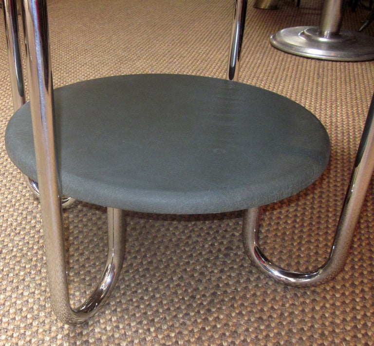 Recently found in Paris and brought to the United States, this two tiered table displays different details from its' American version. The American tops are typically wooden, or a Formica laminate with metal sides. Ours is in original charcoal grey