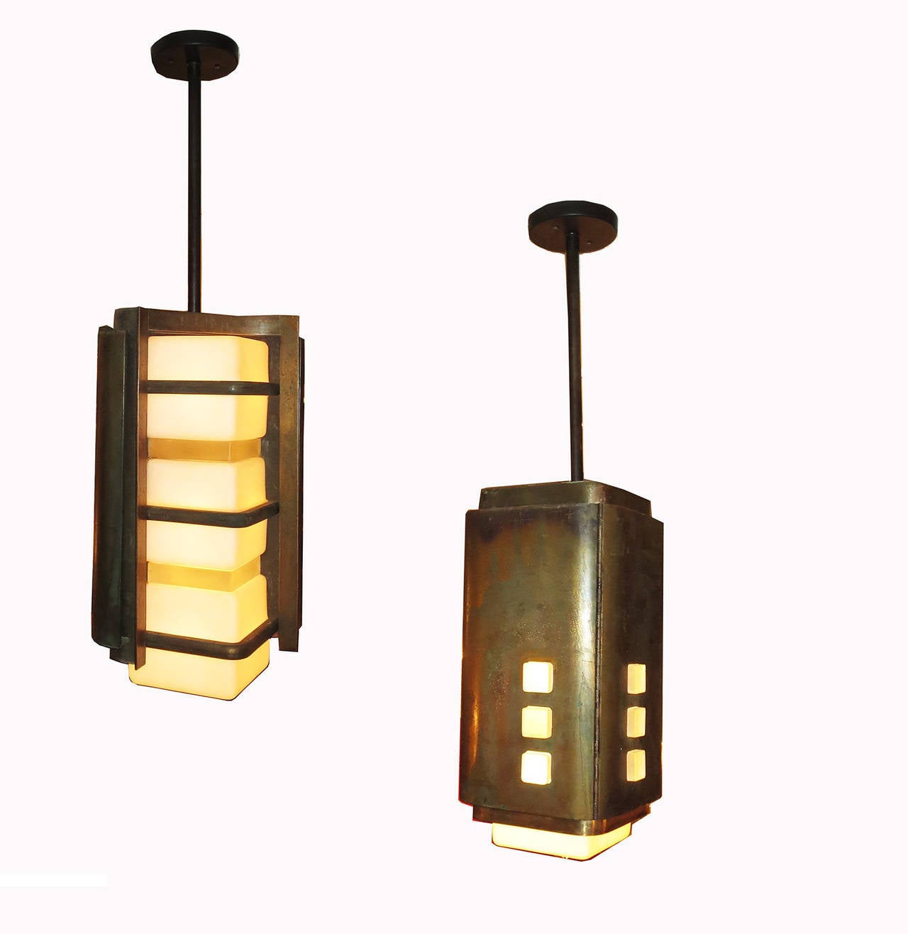 This fantastic pair of originally graced a Mid-Century Modern architectural building here in Southern California. Created by an unknown architect or designer, the lamps display all the hallmarks of post Frank Lloyd Wright modernism. The cabinets are