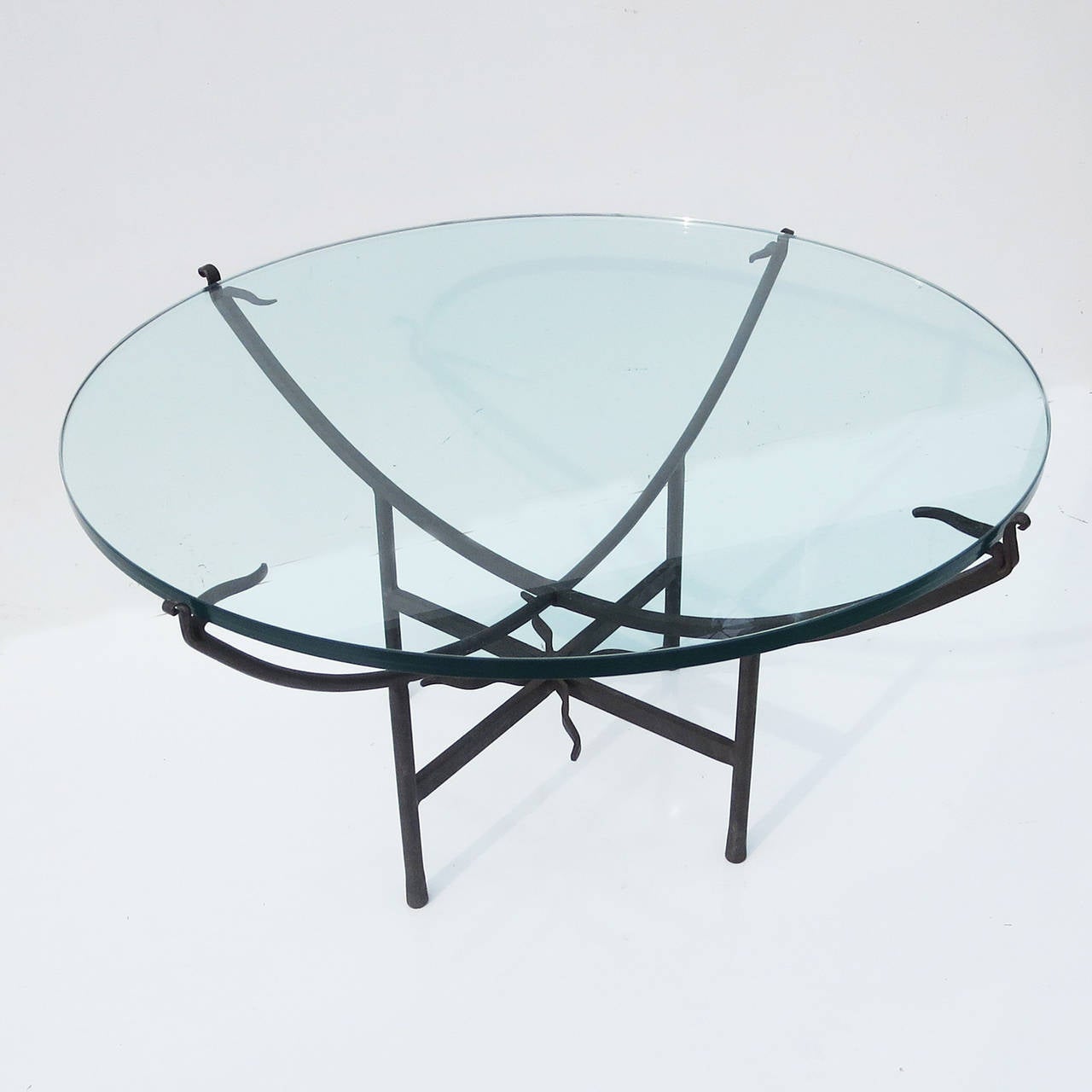 A great design of clean lines and modern influence. The table can be used in an interior or exterior setting. All iron and polished glass top are in excellent original condition, and display very well.