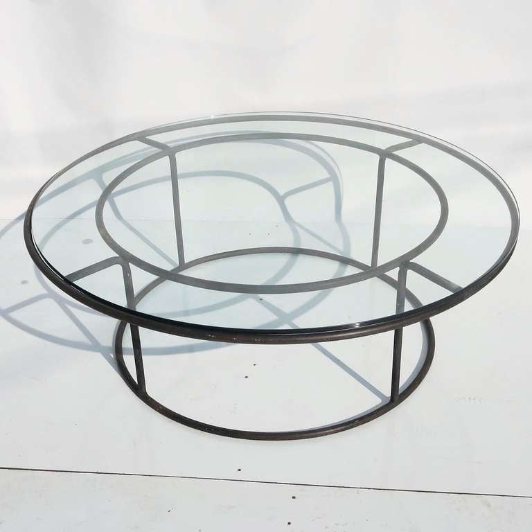 A classic design by Walter Lamb for Brown and Jordan. The original designs of this furniture were made by salvaged bronze tubing, taken from the sunken warships at Pearl Harbor. This low coffee or cocktail table is an unusual example, that rarely