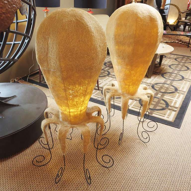 These wonderful and whimsical lamps were made sometime in the late 1960s or early 1970s. They are a spun stiff fiber material, similar to fiberglass. The 