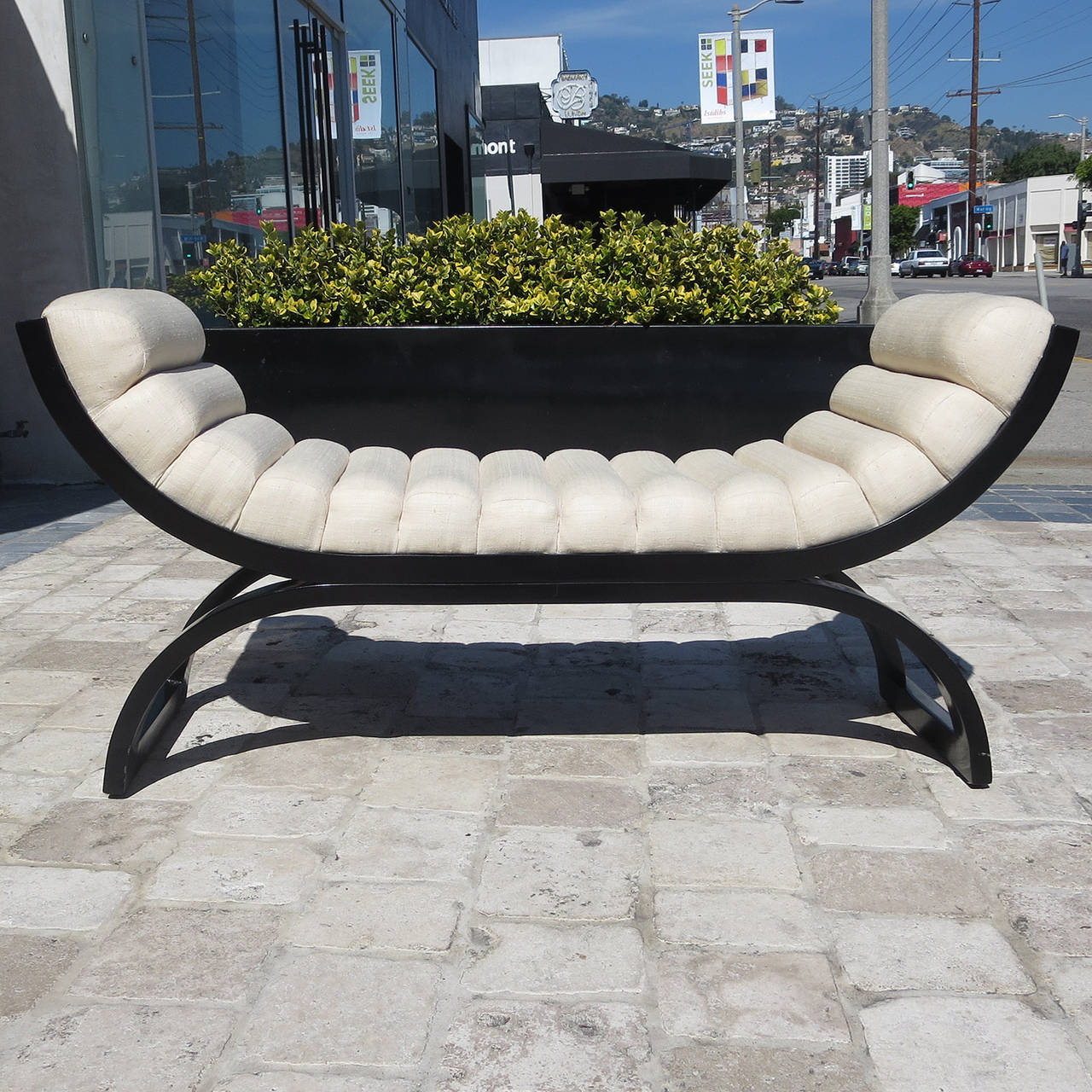 A Classic and comfortable design by Jay Spectre (American 1929-1992). The design refers to the creators' admiration of Art Deco forms. The bench is well proportioned and beautifully built. Lacquered wood is complimented by a lushly padded seat in a