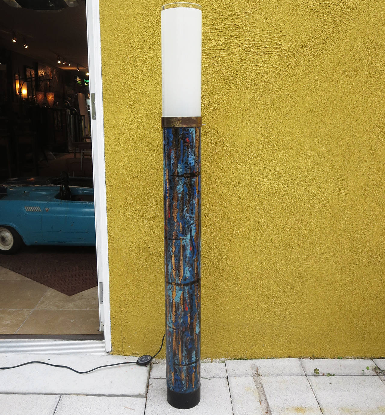 This wonderful and unique floor lamp is glazed ceramic, topped with a thick molded glass shade. The column is similar to the works of Marcello Fantoni, who created wonderful designs for Raymor in the 1950s and 1960s. Our lamp is in fantastic working