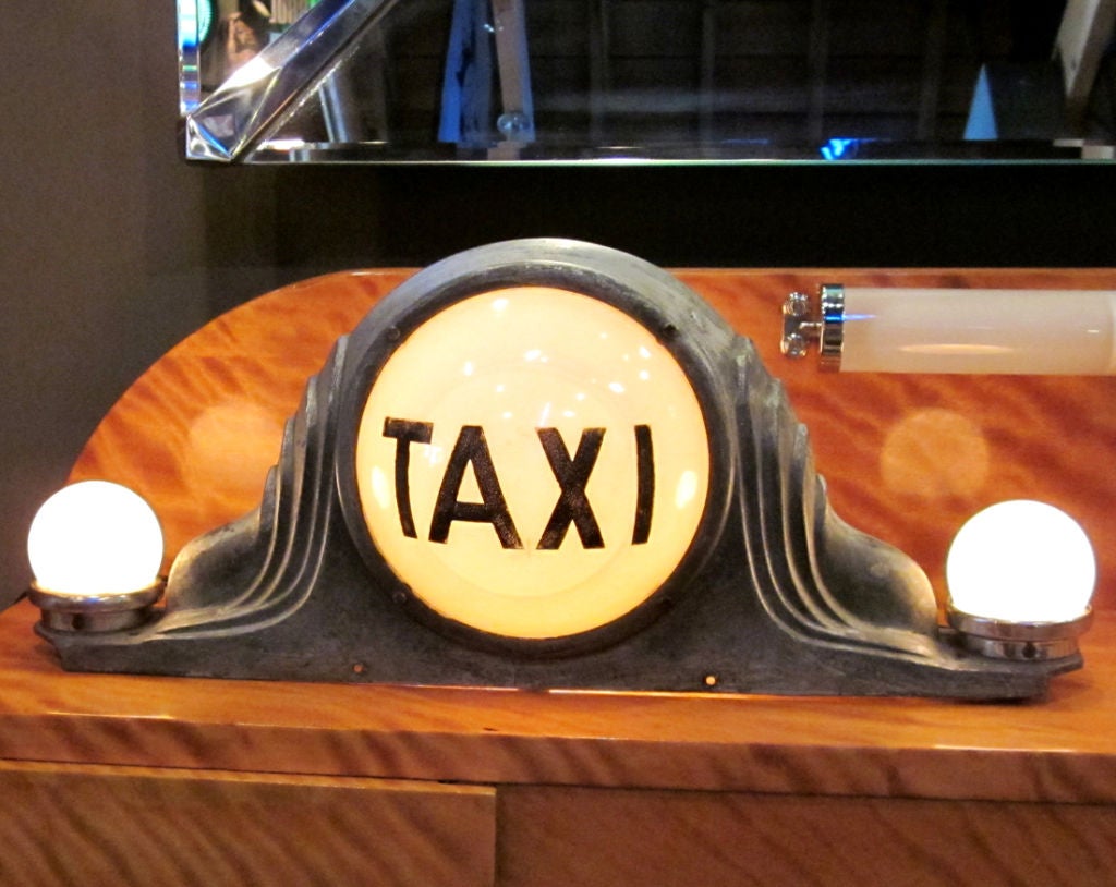 This certainly has to be the earliest version we have seen of a lighted Taxi top light. The case is cast and painted metal, with a great old patina. The 