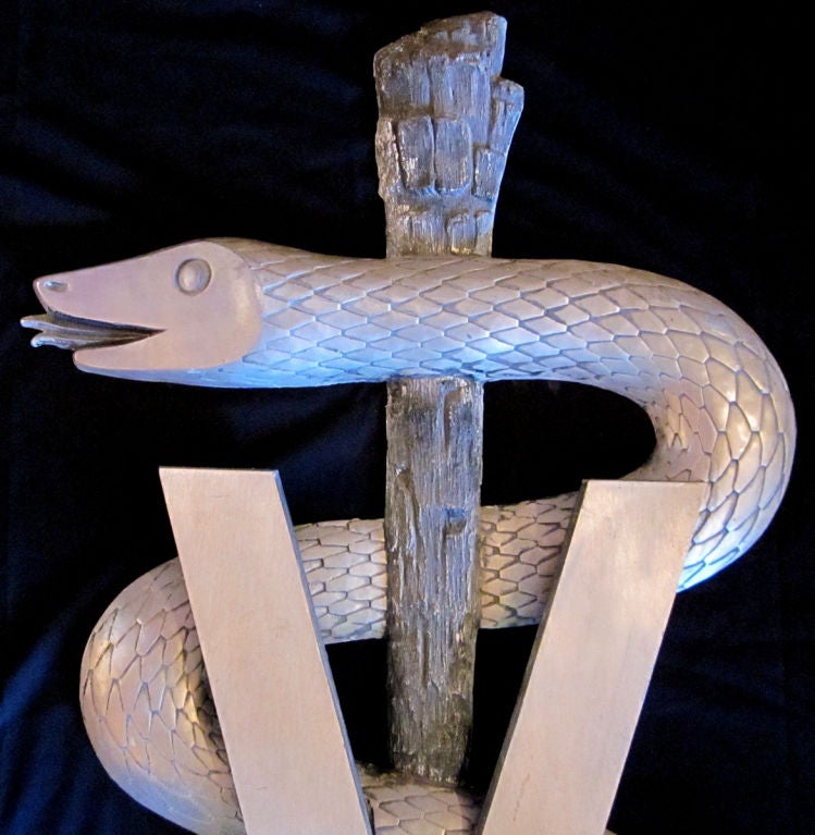 The curled snake symbolized medicine, and is called a Caduceus. We have had them for doctors and dentist offices, and now this V for Veterinary medicine. He is cast aluminum, and formed in two parts, with the V screwing onto the snake from behind.