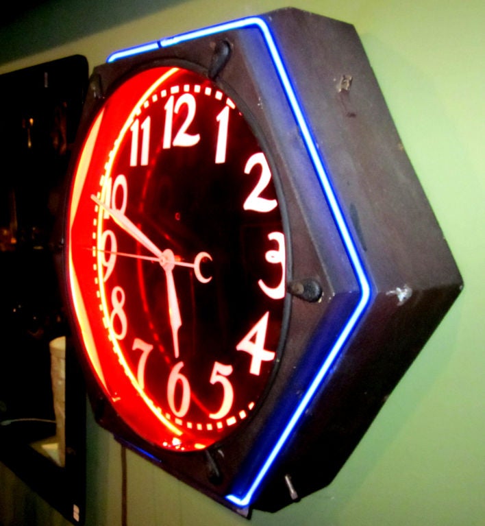 As most of the neon wall clocks were round, this hexagon shape is a unique and attractive alternative. The inner red tube casts a dark hue over the clock face, while the outer blue tube brilliantly defines the shape. Neon and clock motion work