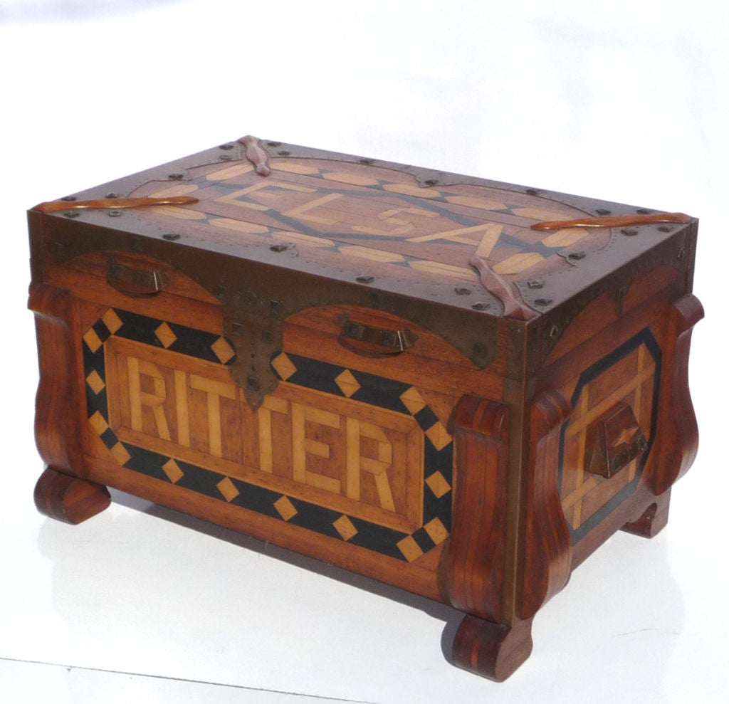 Elsa Ritter must have been the apple of someone's eye, as much love and care went into the construction of her wooden Hope chest. The body of the chest is created by joining multiple pieces of mahogany and maple woods, and reinforced with beautiful