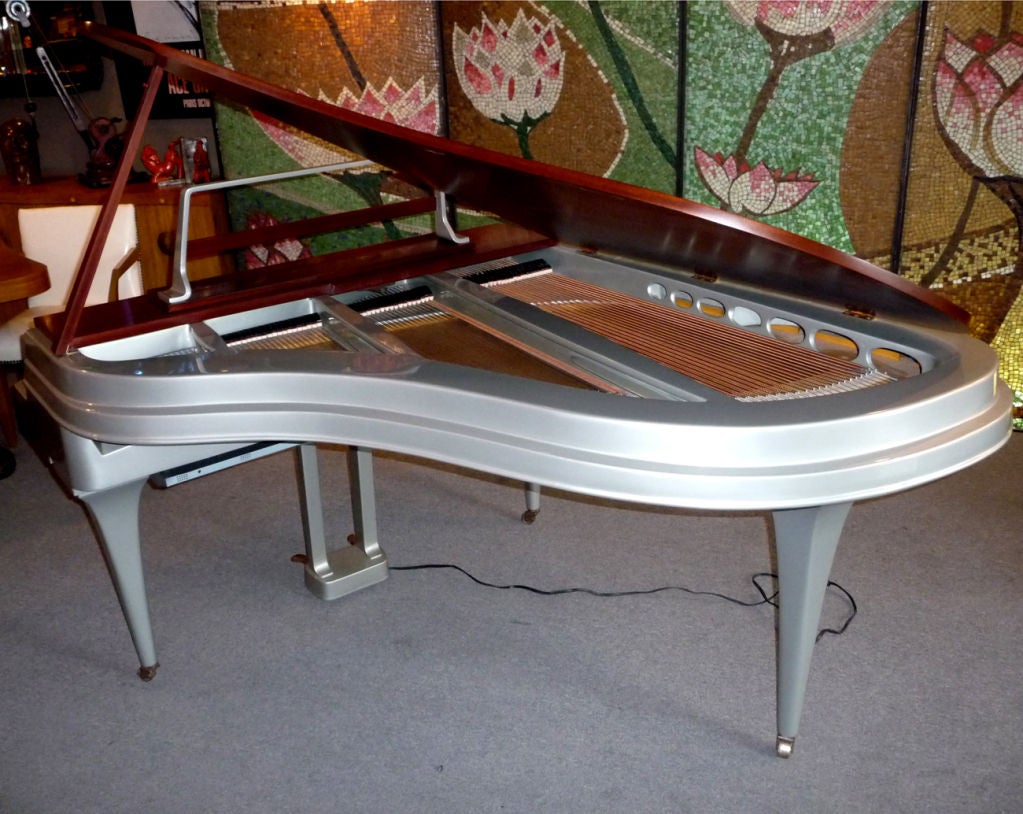 A fantastic instrument cased in a spectacular cabinet! The Rippen aluminum bodied piano was a revolutionary design when introduced in the mid 1950's. The tensile strength of the cast aluminum cabinet allowed the profile to be much thinner, while