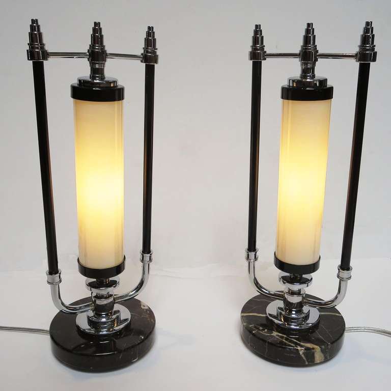 Talk about a skyscraper influence! This lovely pair have been completely re-plated and powder coated, and new wiring was added. The bases are polished marble, with three half round chrome feet. The lamp has a small rotor switch on the base to