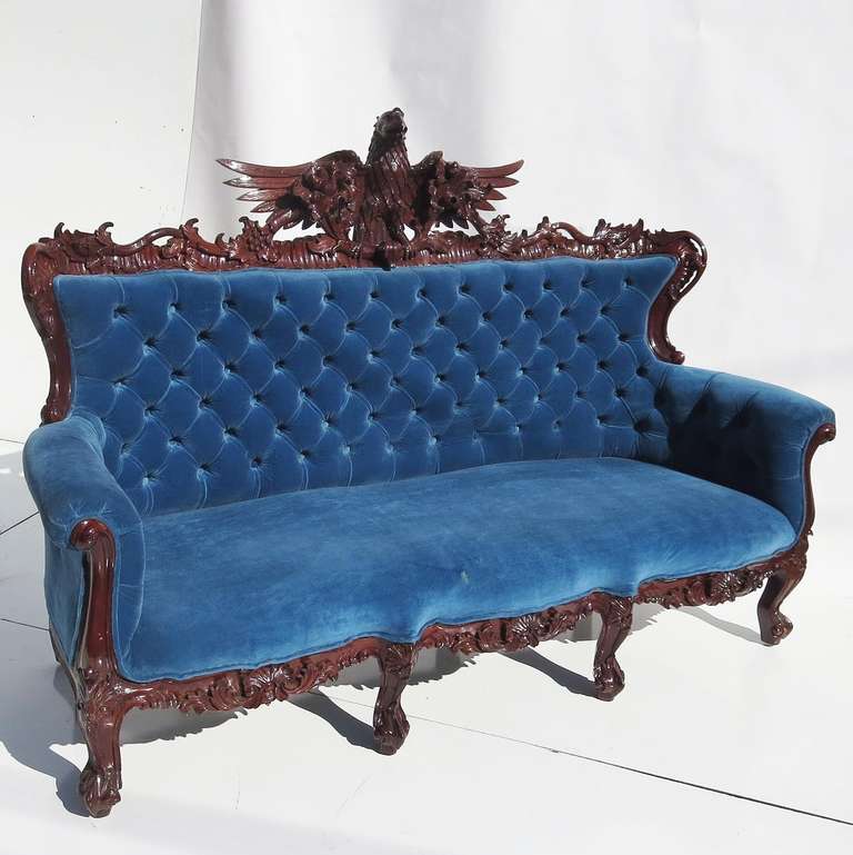 Could this fantastic sofa have once occupied a State house, or Governors mansion? The American eagle is proudly featured in an elaborately carved sofa frame, and finished in a rich, dark satin sheen. The birds' tail even drapes down the back side,