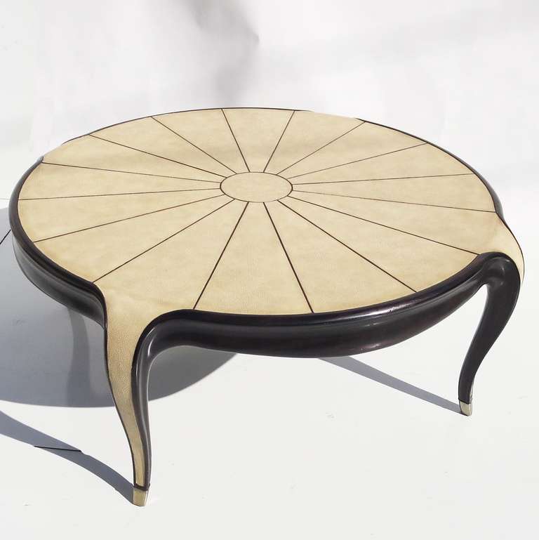 This lovely table, with flowing lines and sunburst motif top, was created during the Art Deco Revival of the 1980's. The finely polished wooden surfaces are cut to allow the shagreen to be inset into the design, rather than laid on top. The legs are