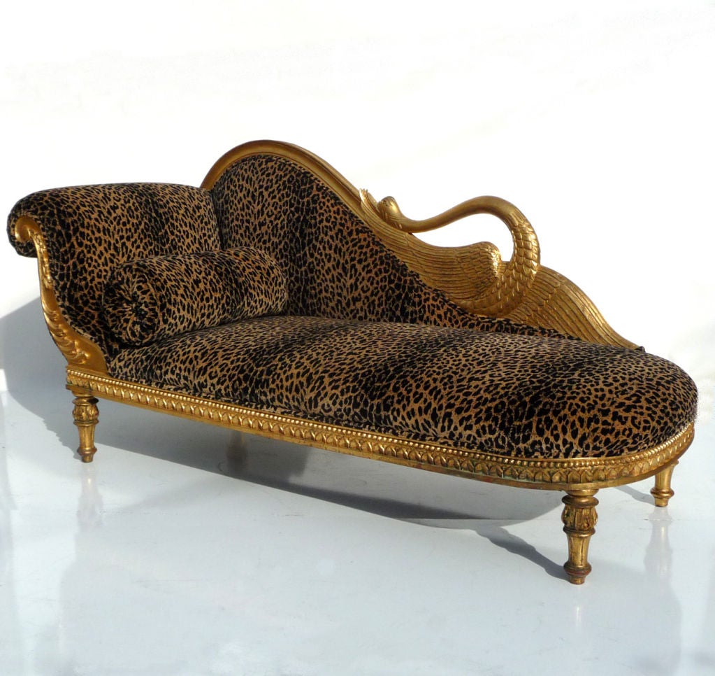 One can only imagine a Hollywood starlet luxuriously lounging here while browsing her latest scripts! This sumptuous sofa really makes quite a statement in its velvet faux leopard covering. All woods are beautifully hand carved and gold leafed to