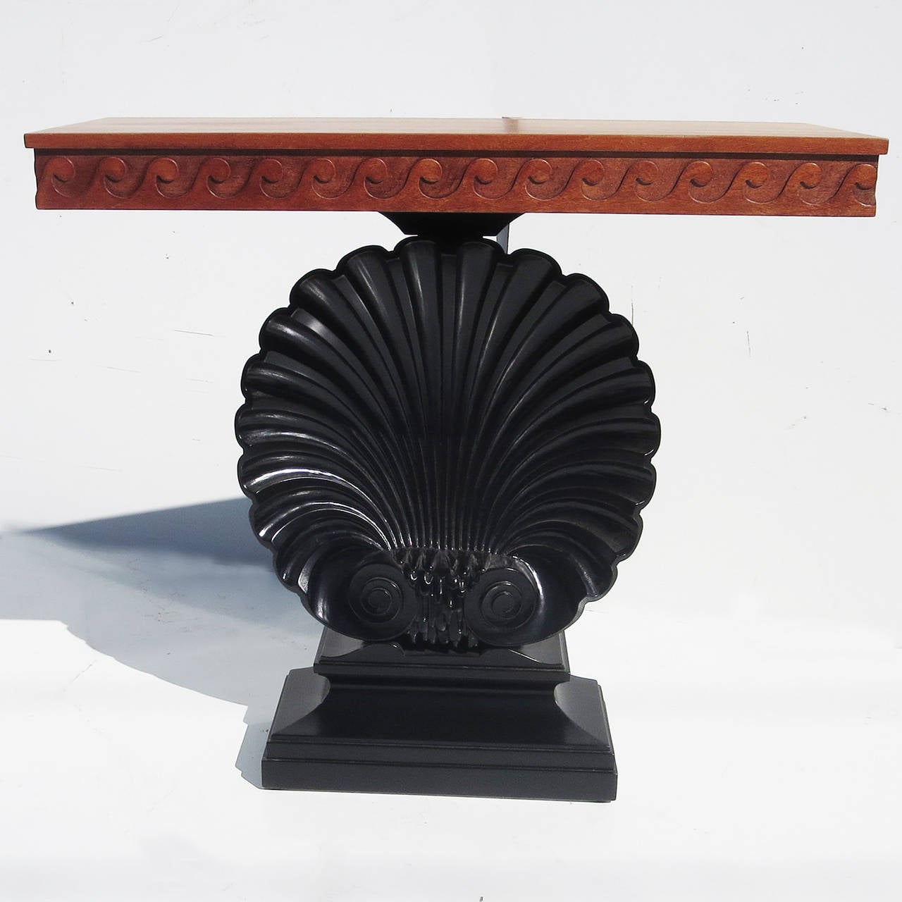 RETIREMENT SALE!!!  EVERYTHING MUST GO - CHECK OUT OUR OTHER ITEMS.				

A beautiful and classic design by Edward Wormley. The solid mahogany console features a hand carved shell form base, and a repeating carved wave pattern to the table edge. The